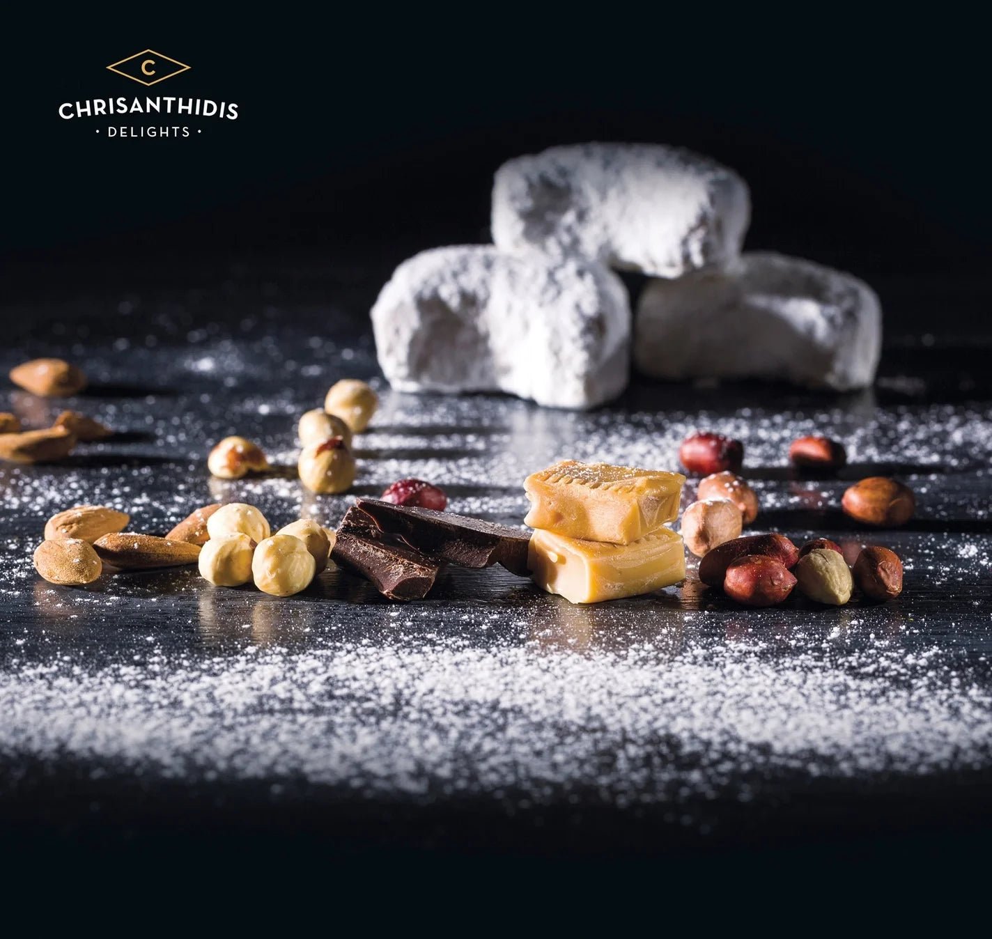 Assorted confectionery items including nougat, nuts, and chocolate on a dark surface with 'Chrisanthidis Delights' branding