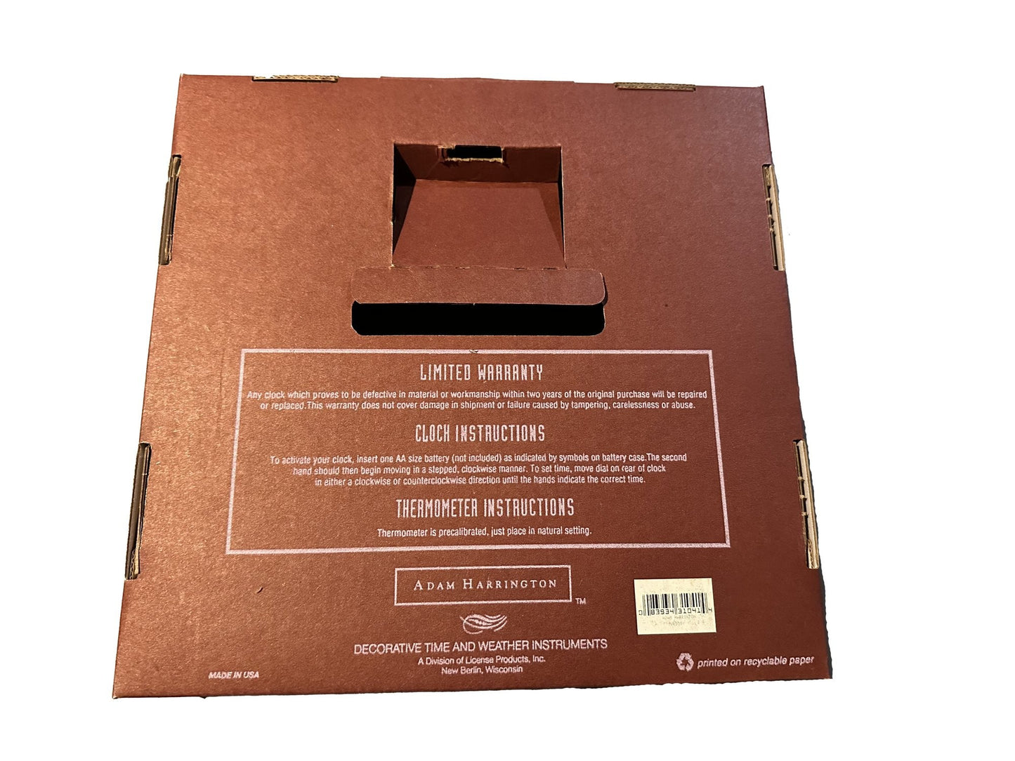Brown cardboard box with clock instruction and manual text and a handle on a white background