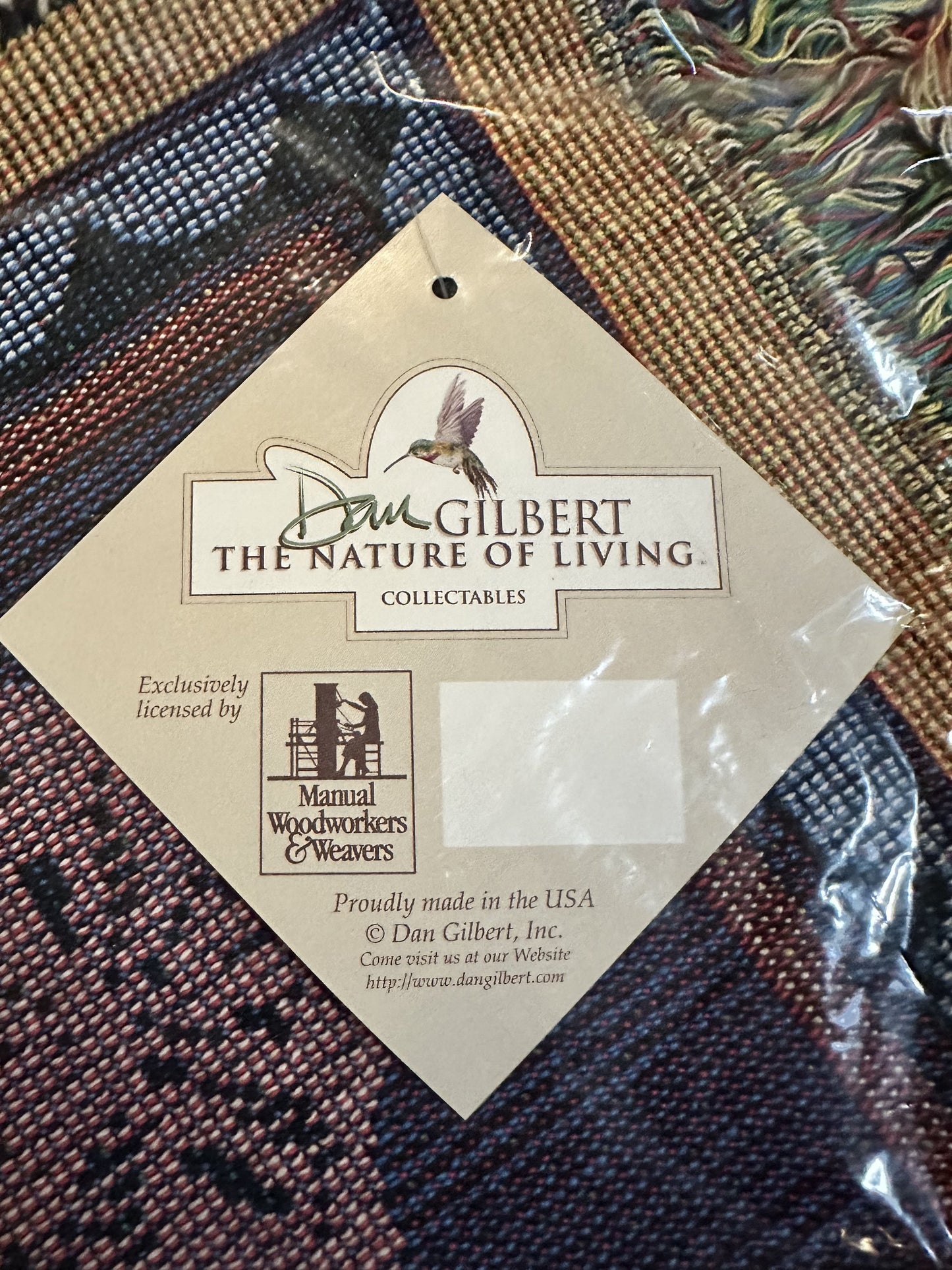 Porpoise Song Throw with 'Dan Gilbert The Nature of Living' label featuring a hummingbird design and Proudly Made in the USA