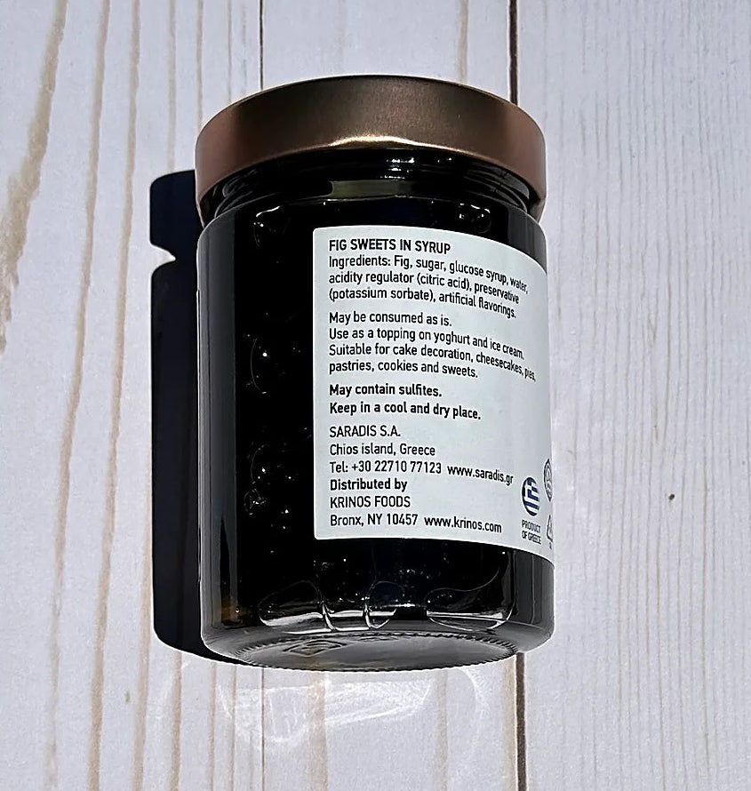 Jar of figs in syrup on a wooden surface
