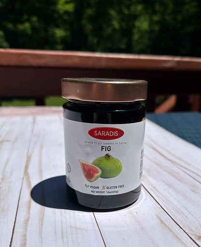 Jar of Saradis fig fruit spread on a wooden table outdoors