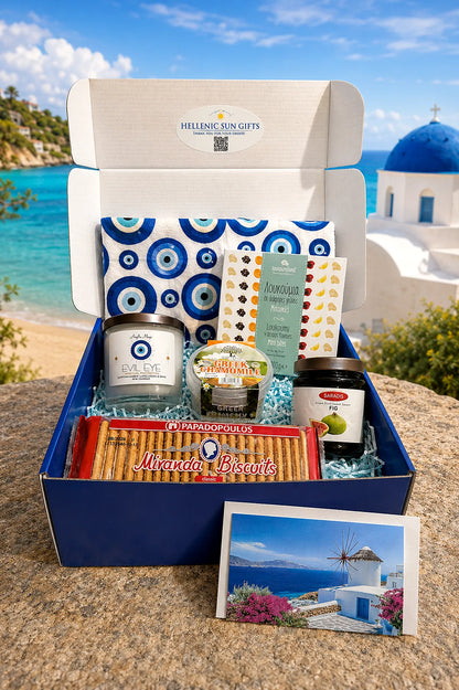 Gift box with Greek-themed products against a scenic background