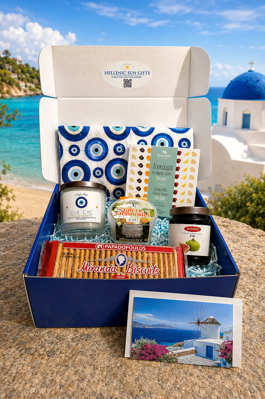 Gift box with Greek-themed products against a scenic background