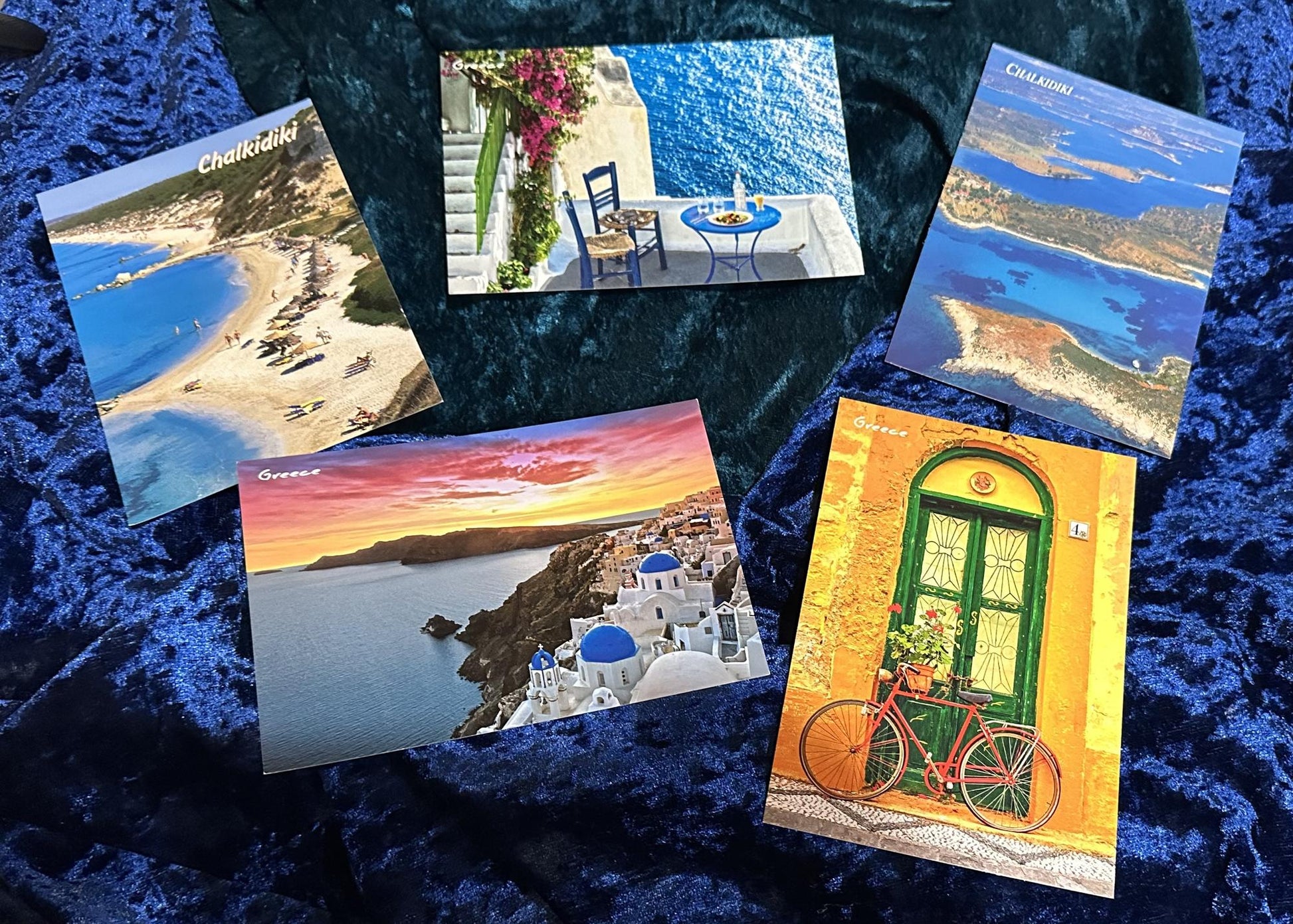 Collection of postcards with scenic views on a textured blue surface