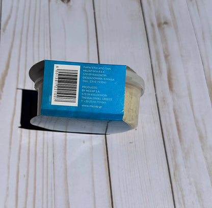 Cylindrical container with blue label on a wooden surface