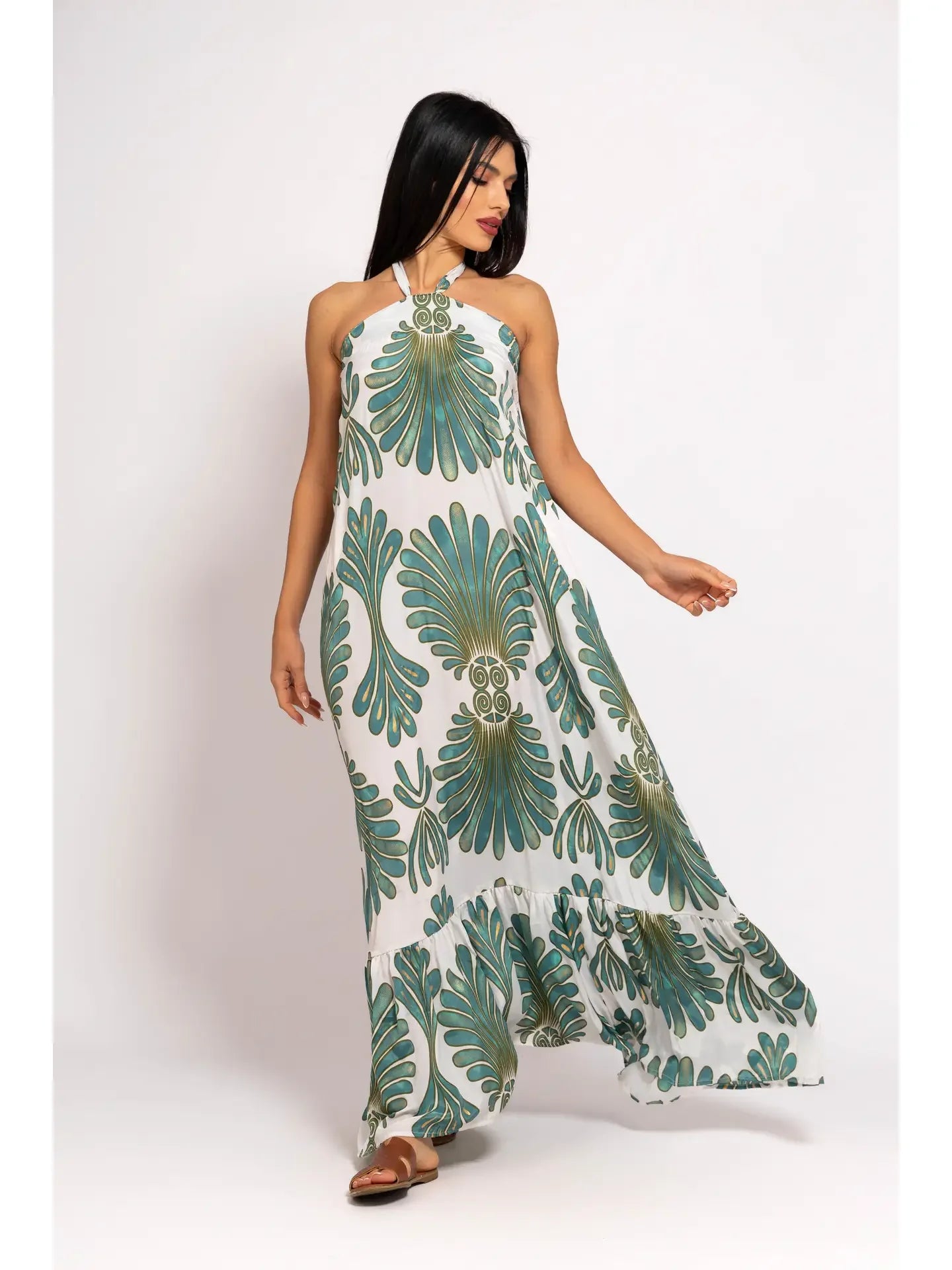 Woman wearing a green and white patterned dress on a white background