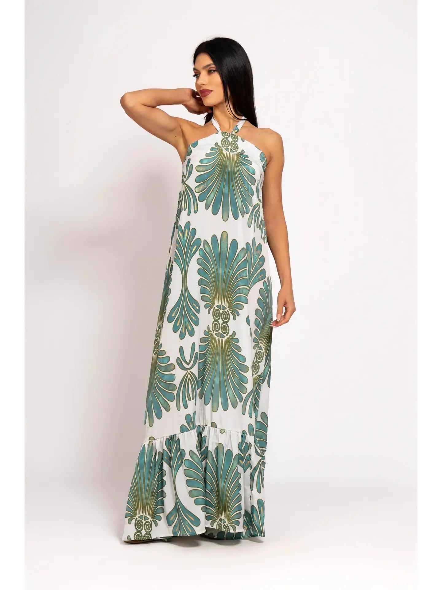 Woman wearing a long floral dress on a white background