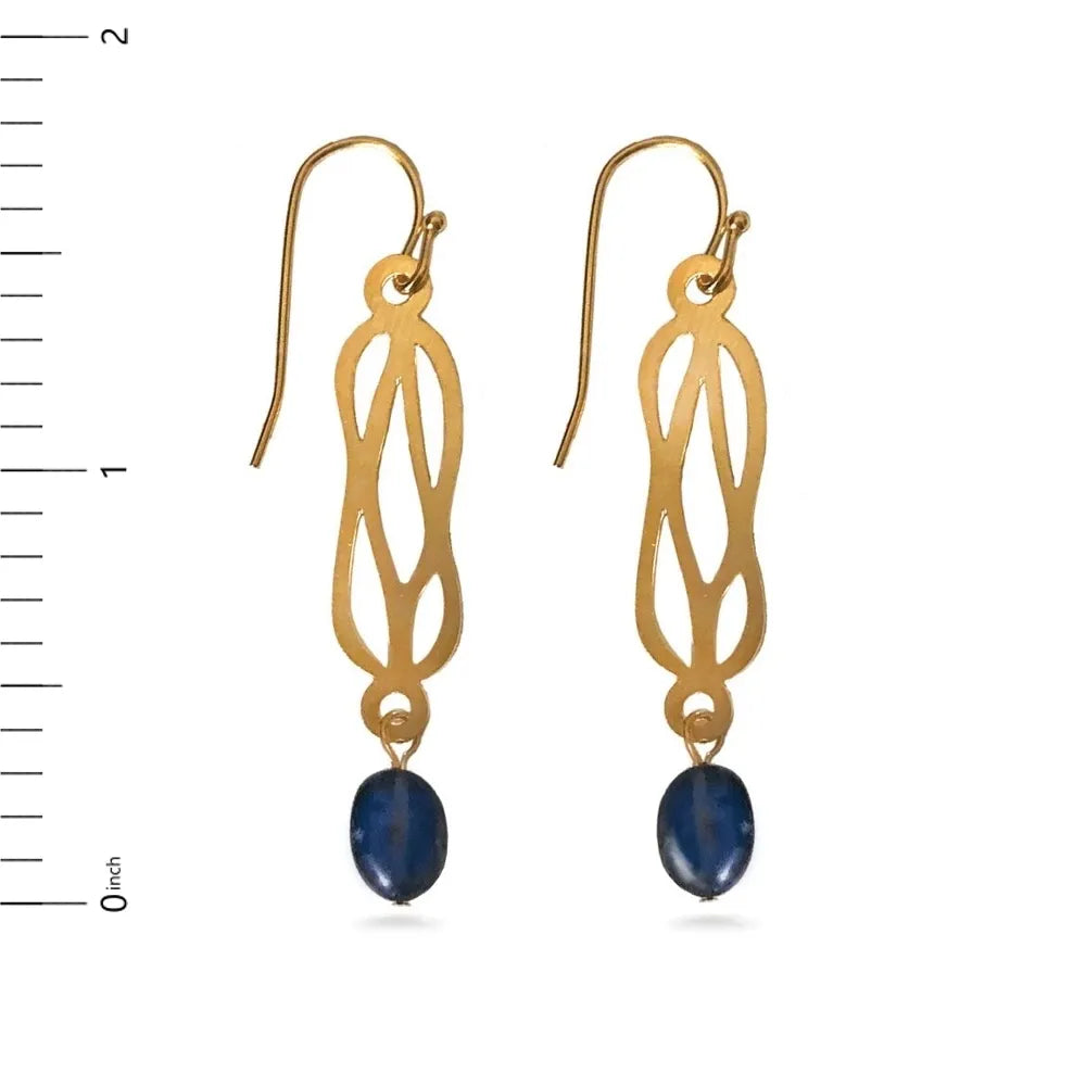 Gold earrings with blue stones next to a ruler on a white background