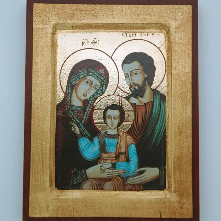 Icon of a religious scene with three figures in a decorative frame.