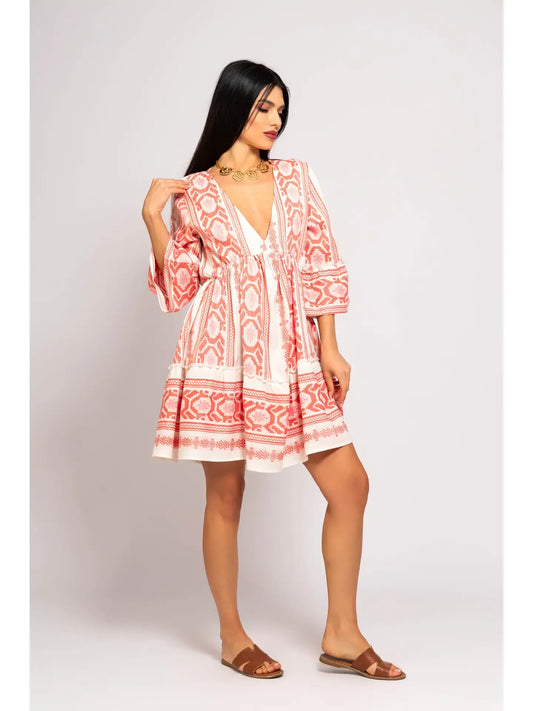 Woman wearing a red and white patterned dress on a white background
