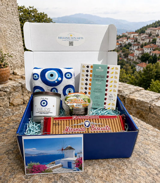 Gift box with Greek-themed products against a scenic background