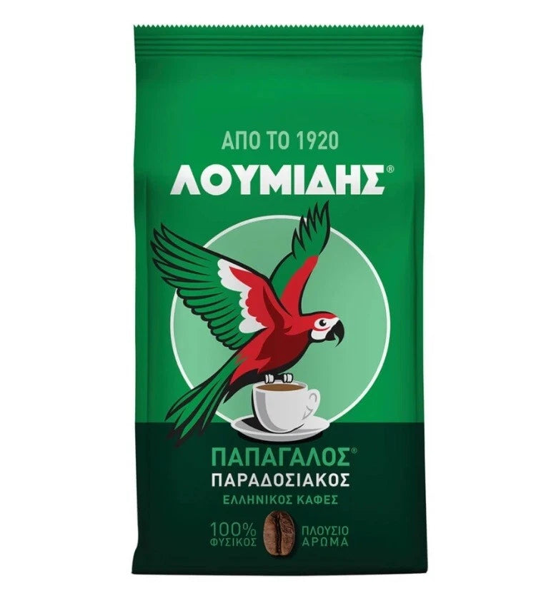 A green bag of Loumids Papadopoulos Paradosiakos Greek coffee, featuring a red and green parrot perched on a cup of coffee with white text on a white background.