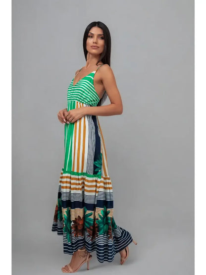 Woman wearing a colorful striped dress on a gray background