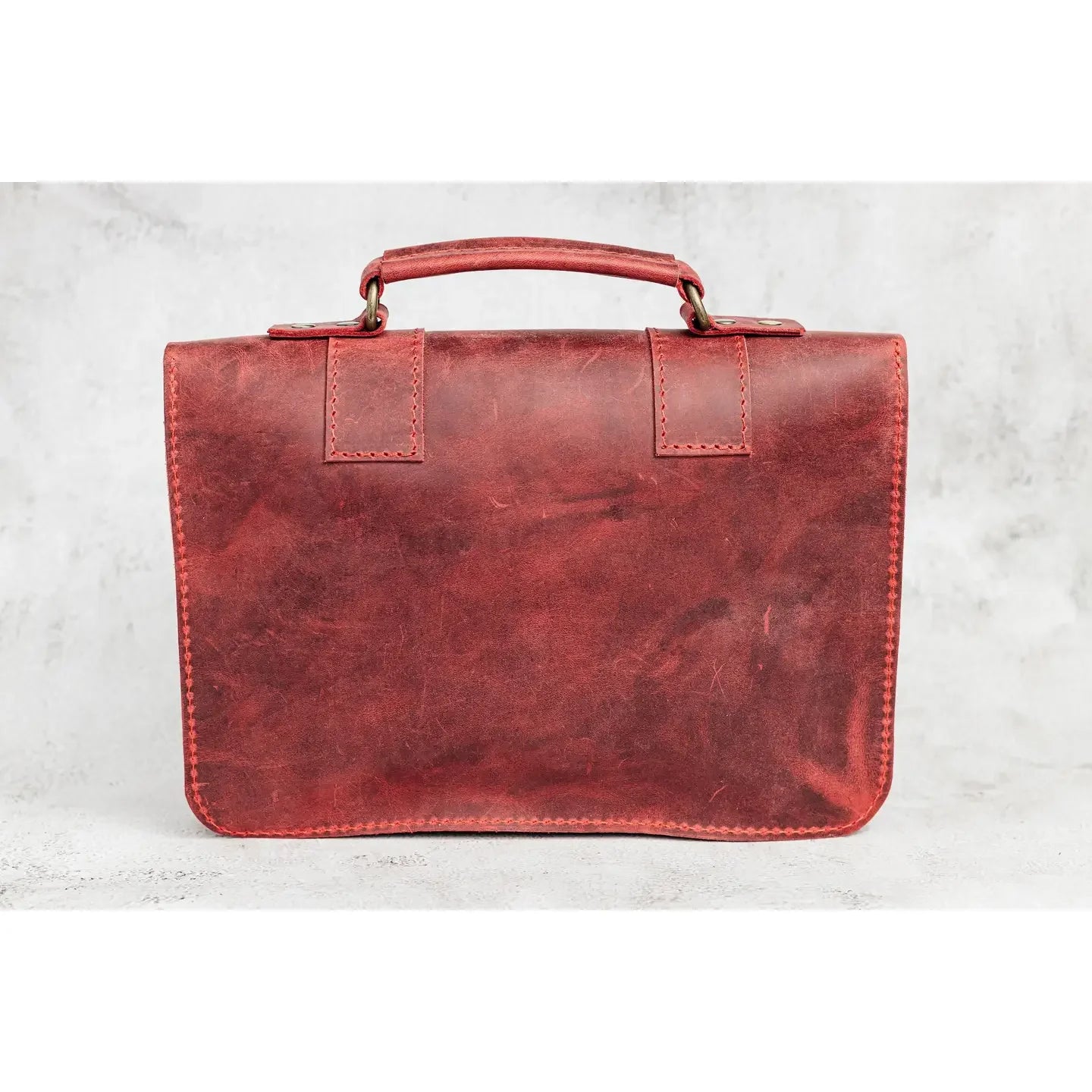 Red leather briefcase on a light gray background