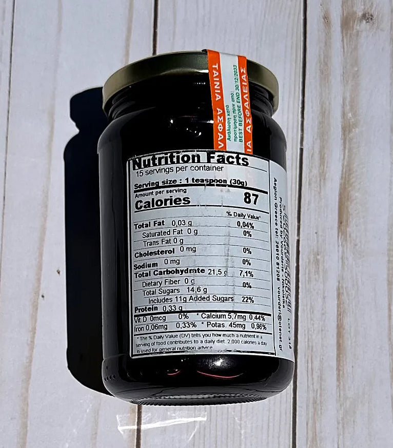 Vouderis Sour Cherry Spoon Sweet Jar  with nutritional label on a wooden surface