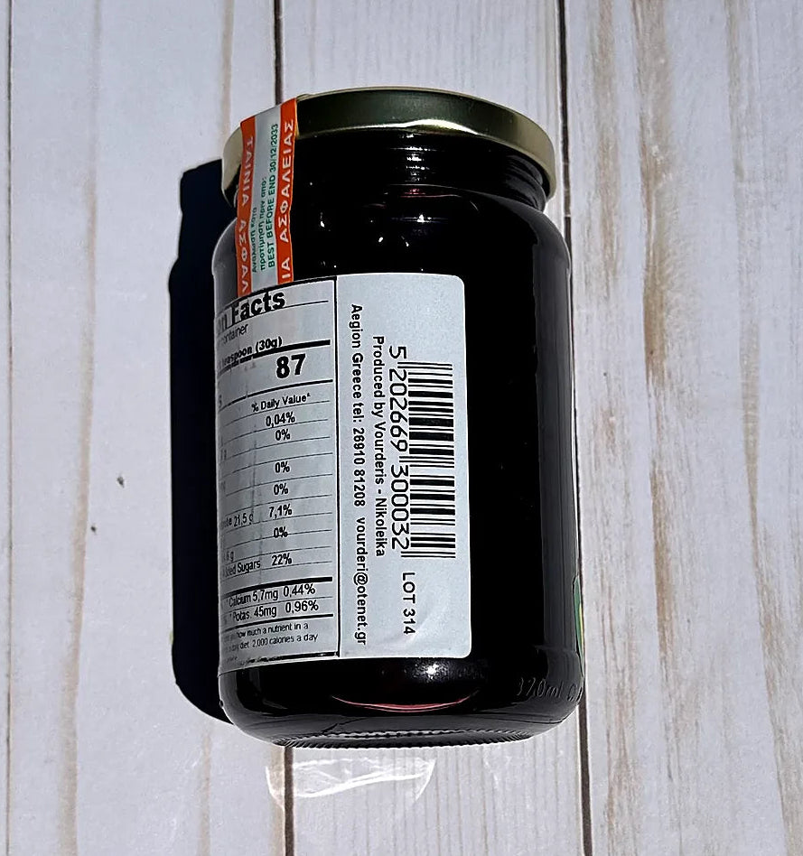 Vouderis Sour Cherry Spoon Sweet Jar with a label on a wooden surface