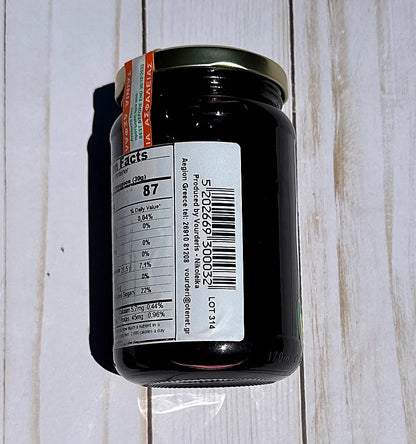 Vouderis Sour Cherry Spoon Sweet Jar with a label on a wooden surface