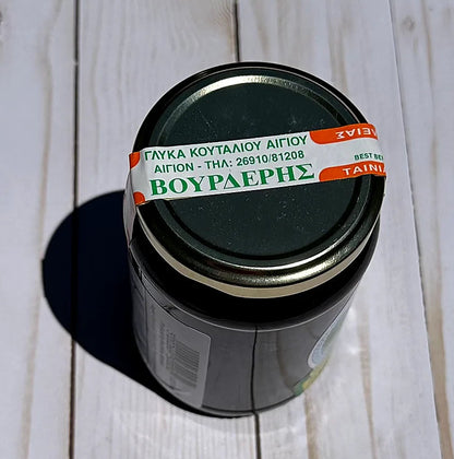 Top of Vouderis Sour Cherry Spoon Sweet Jar with a label on a wooden surface