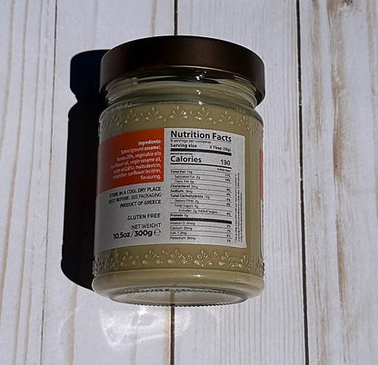 Olympos Tahini Jar with a nutritional label on a wooden surface