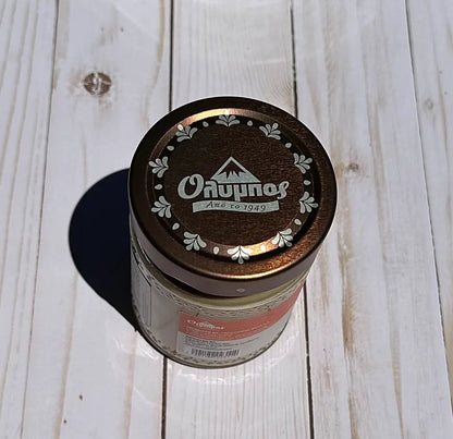 Olympos Tahini with a lid on a wooden surface
