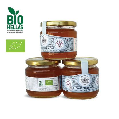 Three jars of honey stacked on a white background with Bio Hellas logo
