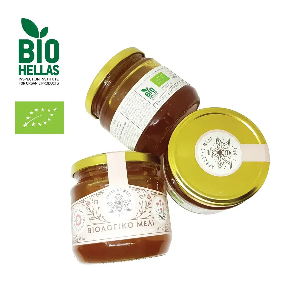 Three jars of honey with labels on a white background, featuring the Bio Hellas logo.