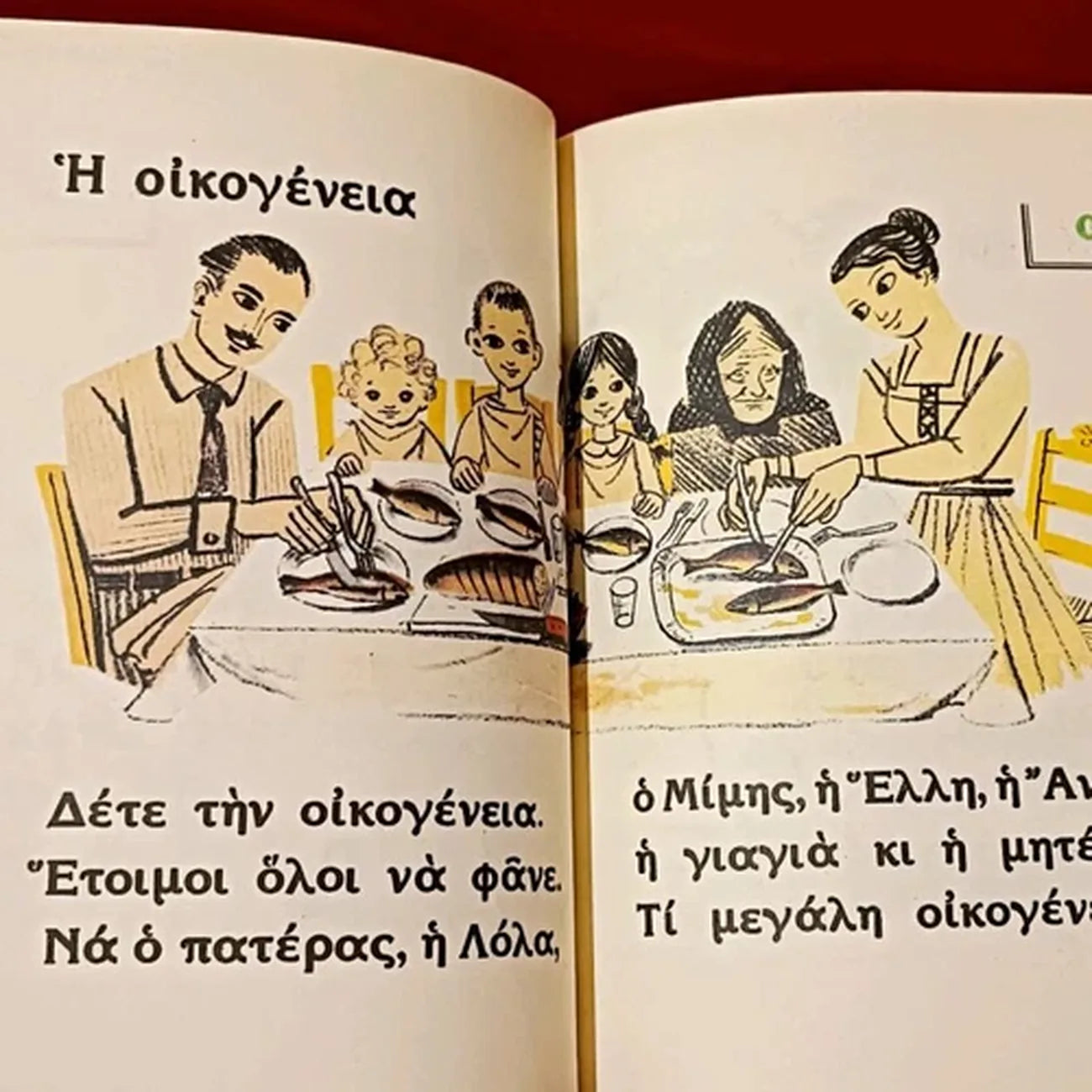 Open book with illustrations of a family at dinner and Greek text.