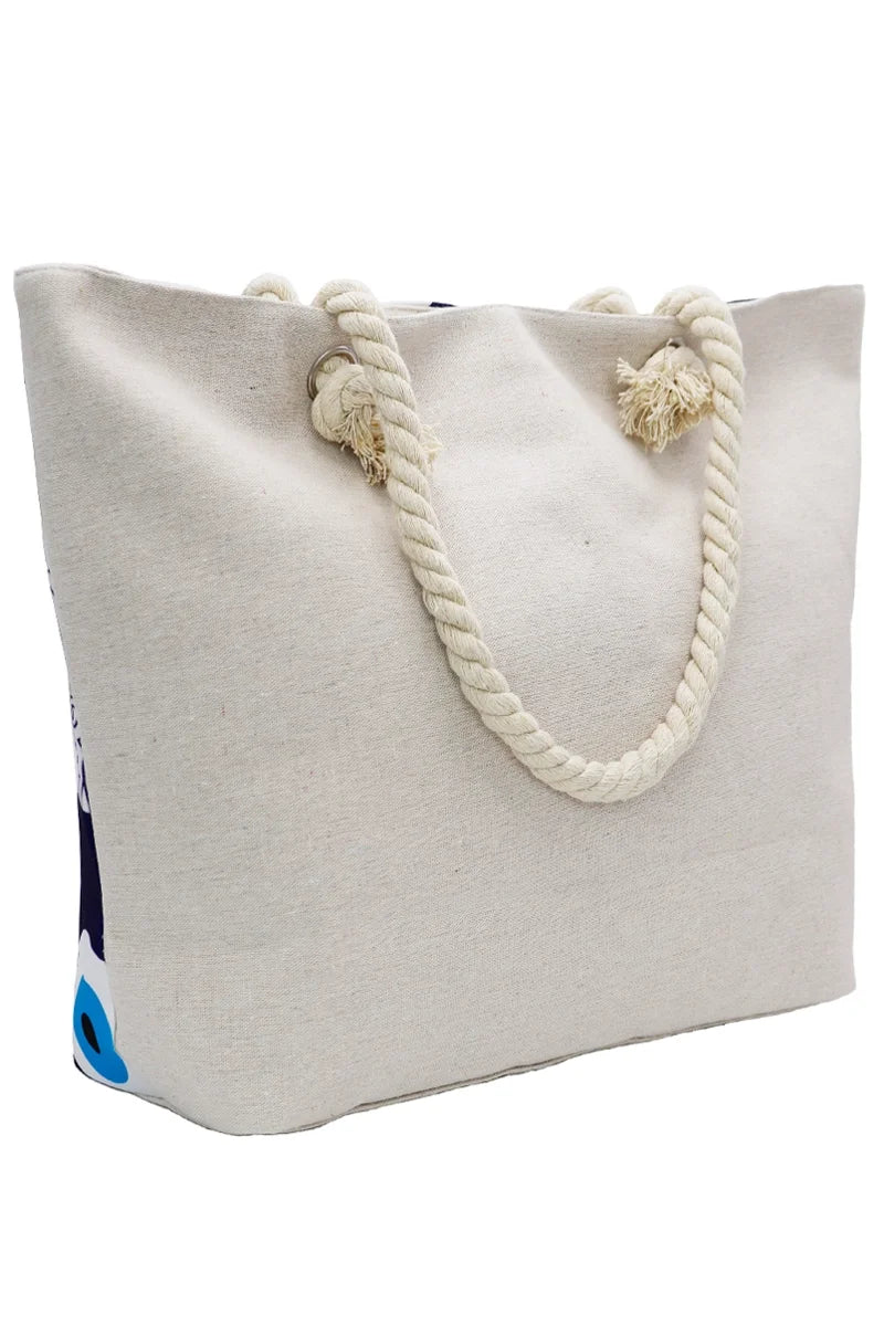 Off-white tote bag with rope handles and a peek of the evil eye design on a white background - back view 