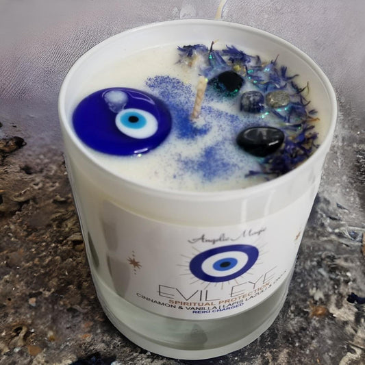 Evil Eye candle with decorative elements on a textured surface