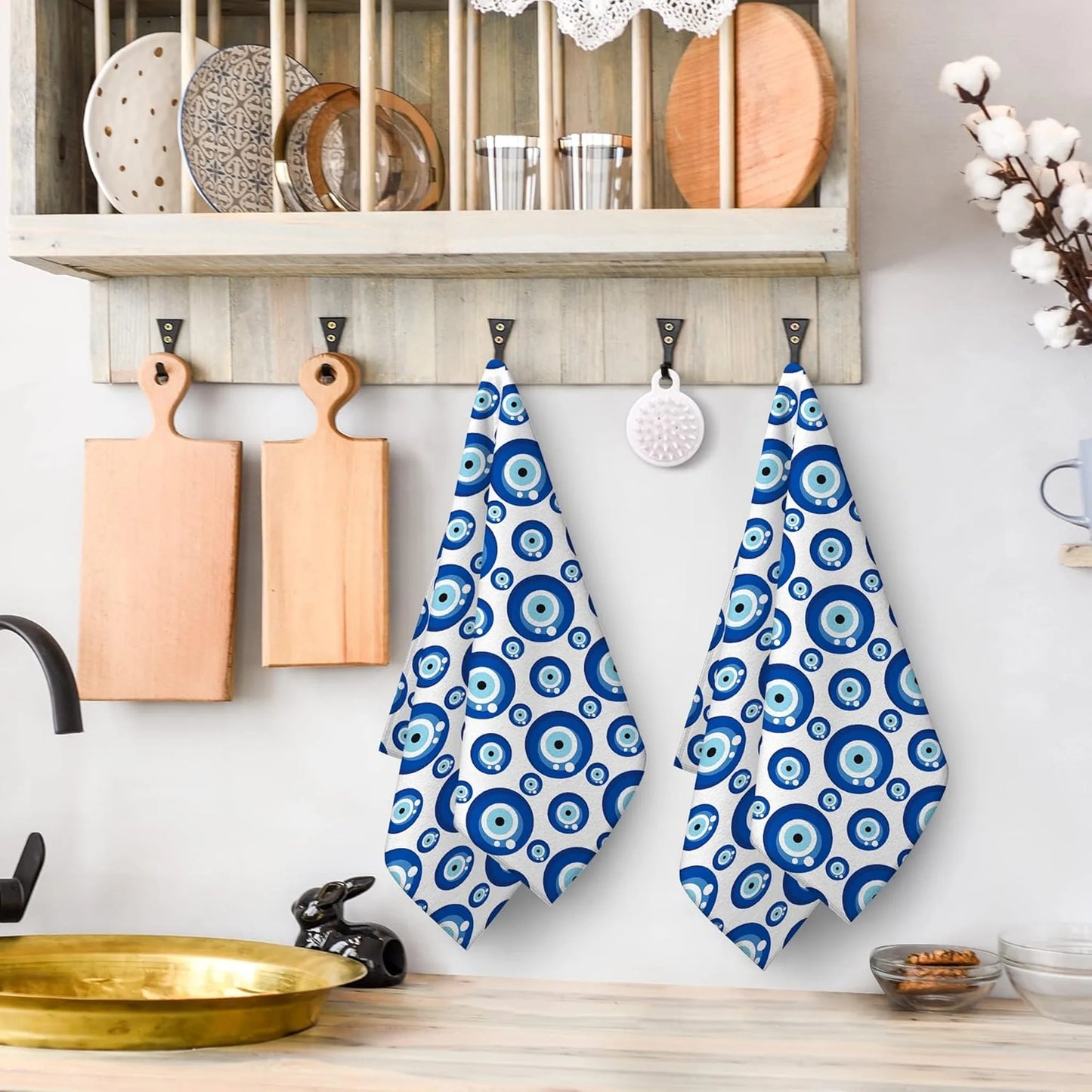 Blue and white patterned towels hanging on a wooden hook in a kitchen
