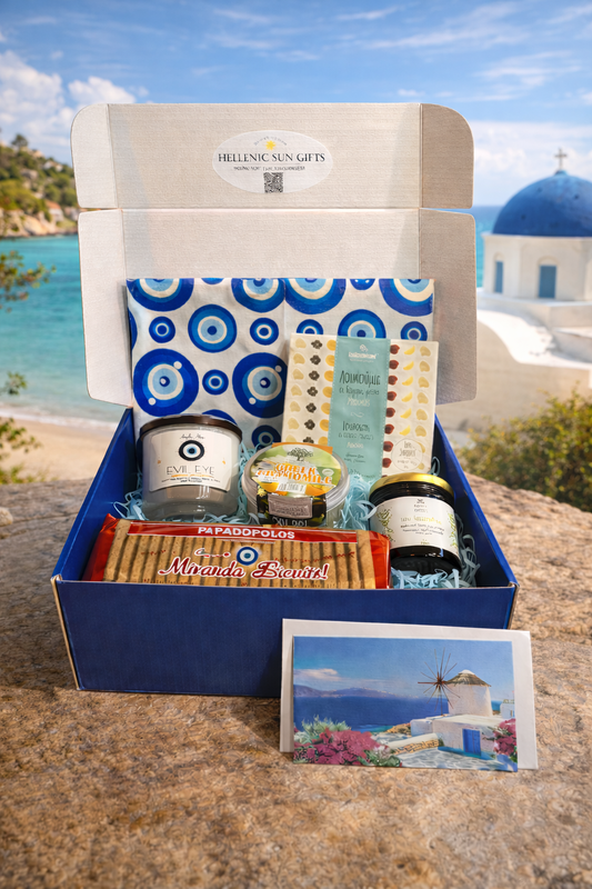 Gift box with Greek-themed products against a scenic background
