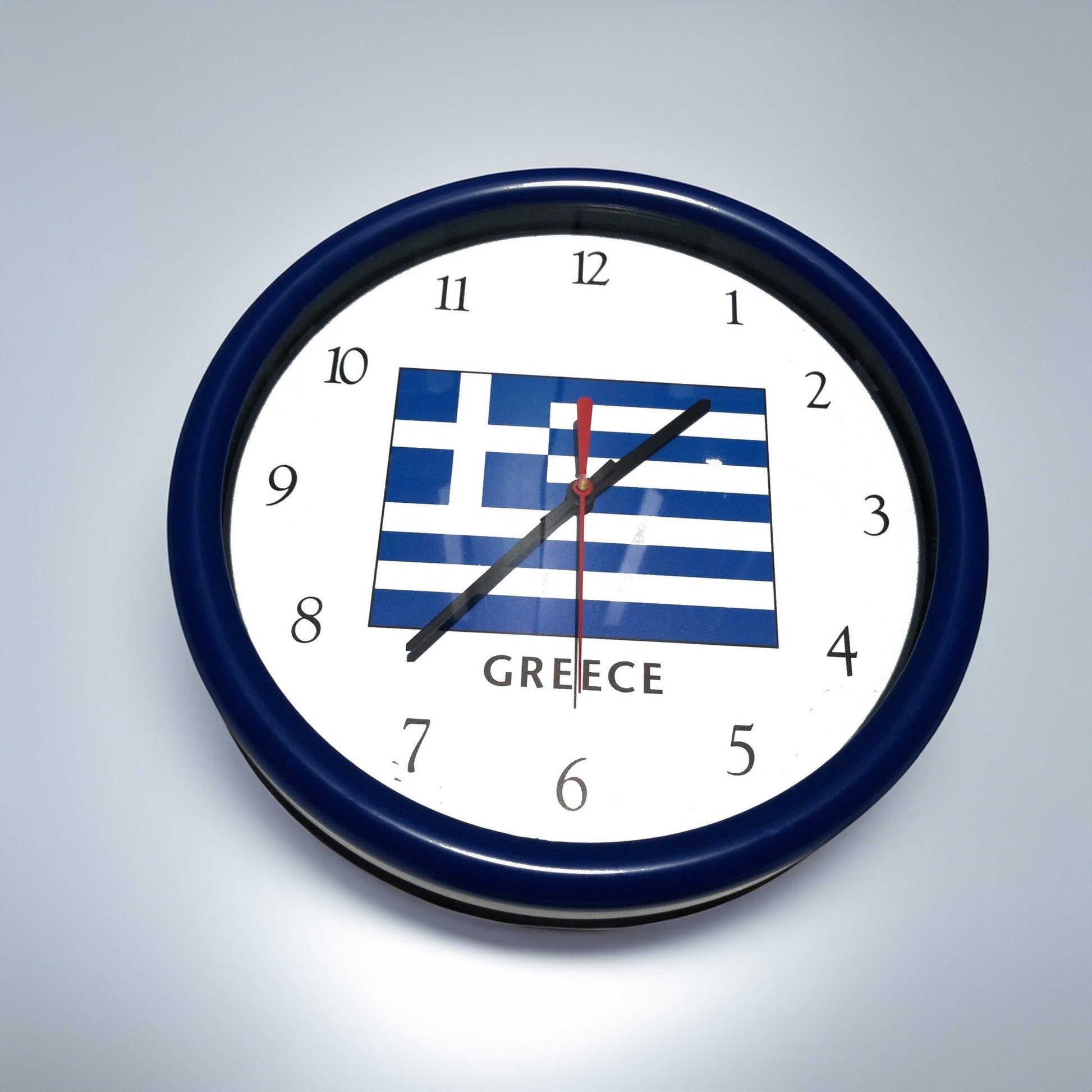 Wall clock with Greek flag design on a gray background