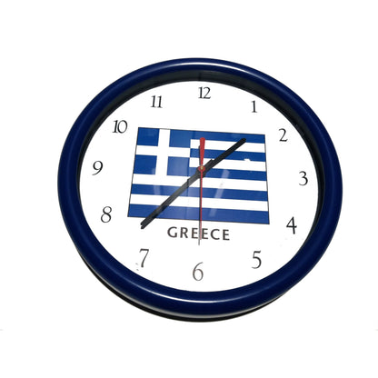 Wall clock with Greek flag design on a white wall background