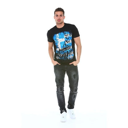 Man wearing a black t-shirt with a blue graphic design and dark jeans on a white background