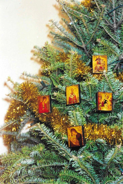 Decorative Christmas tree with religious-themed Greek icon ornaments and gold tinsel