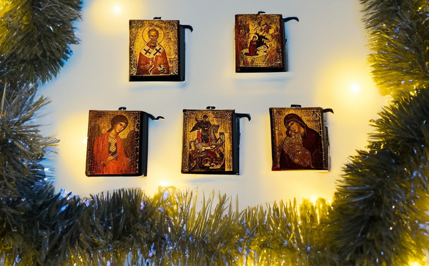 Set of religious icon miniatures on a white background with Christmas decorations