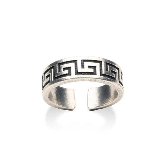 Silver ring with a Greek key design on a white background