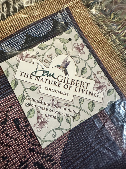 Porpoise Song Throw with 'Dan Gilbert The Nature of Living' label featuring a hummingbird design