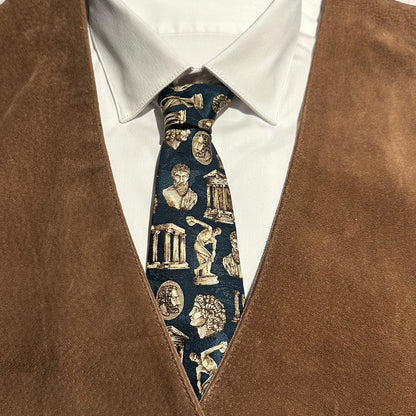 Close-up of a tie with classical design worn with a brown vest and white shirt