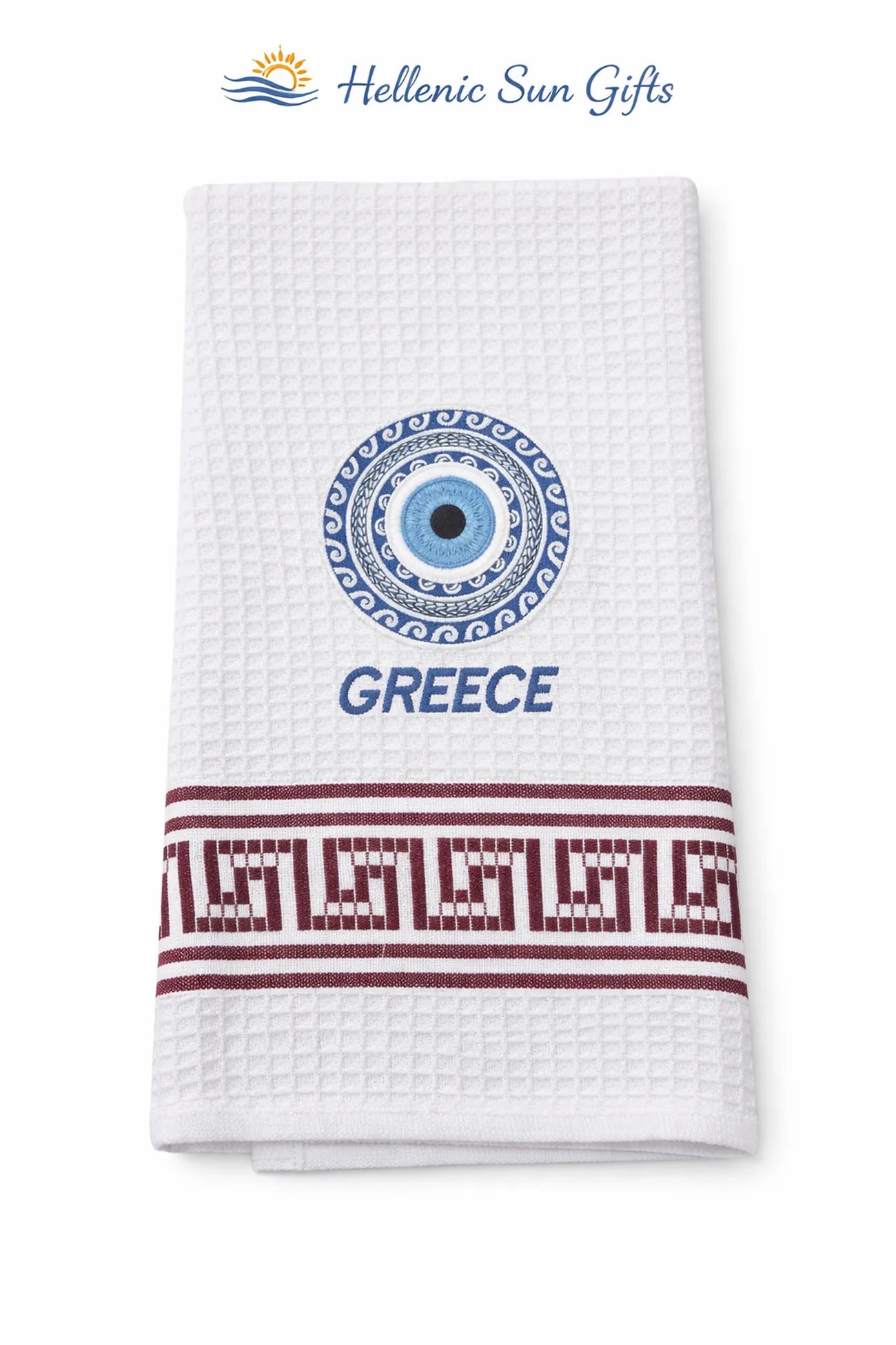 White waffle weave cotton dish towel with Greek evil eye design and 'GREECE' in text with a Greek key design on a white background