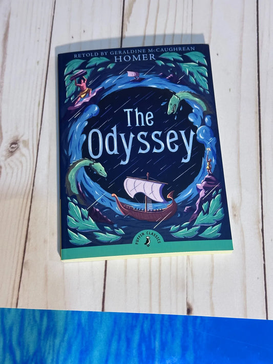 Book titled 'The Odyssey' by Homer on a wooden surface