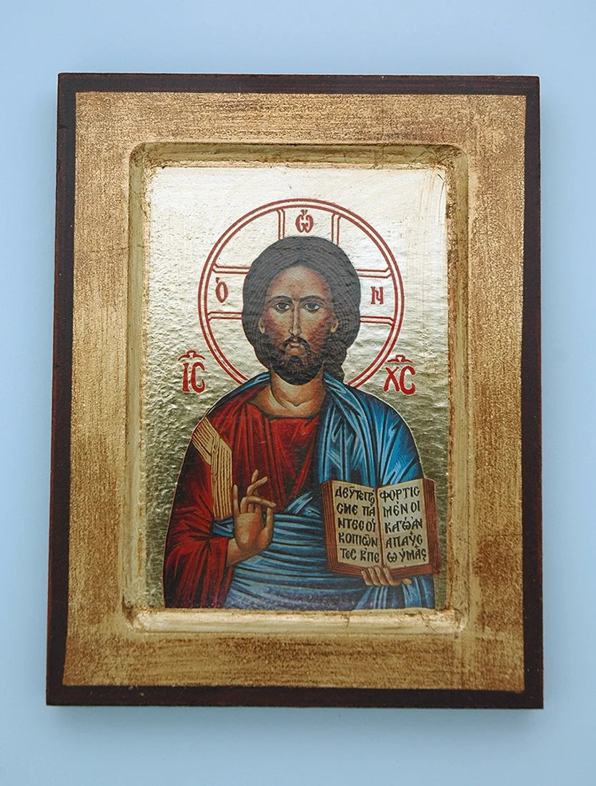 Framed icon of a religious figure with gold detailing on a blue background