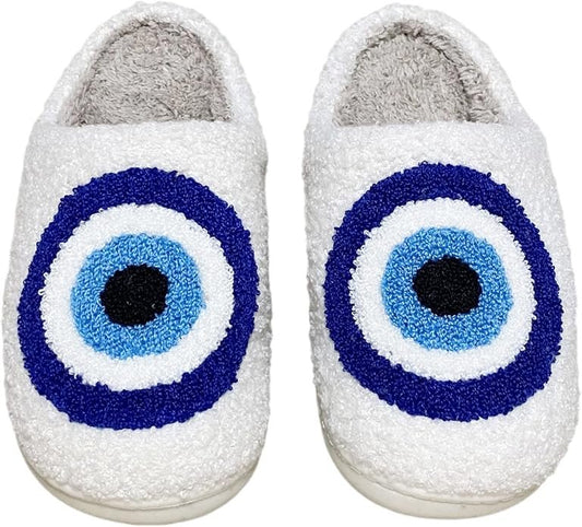 White slippers with blue and black eye design on a white background