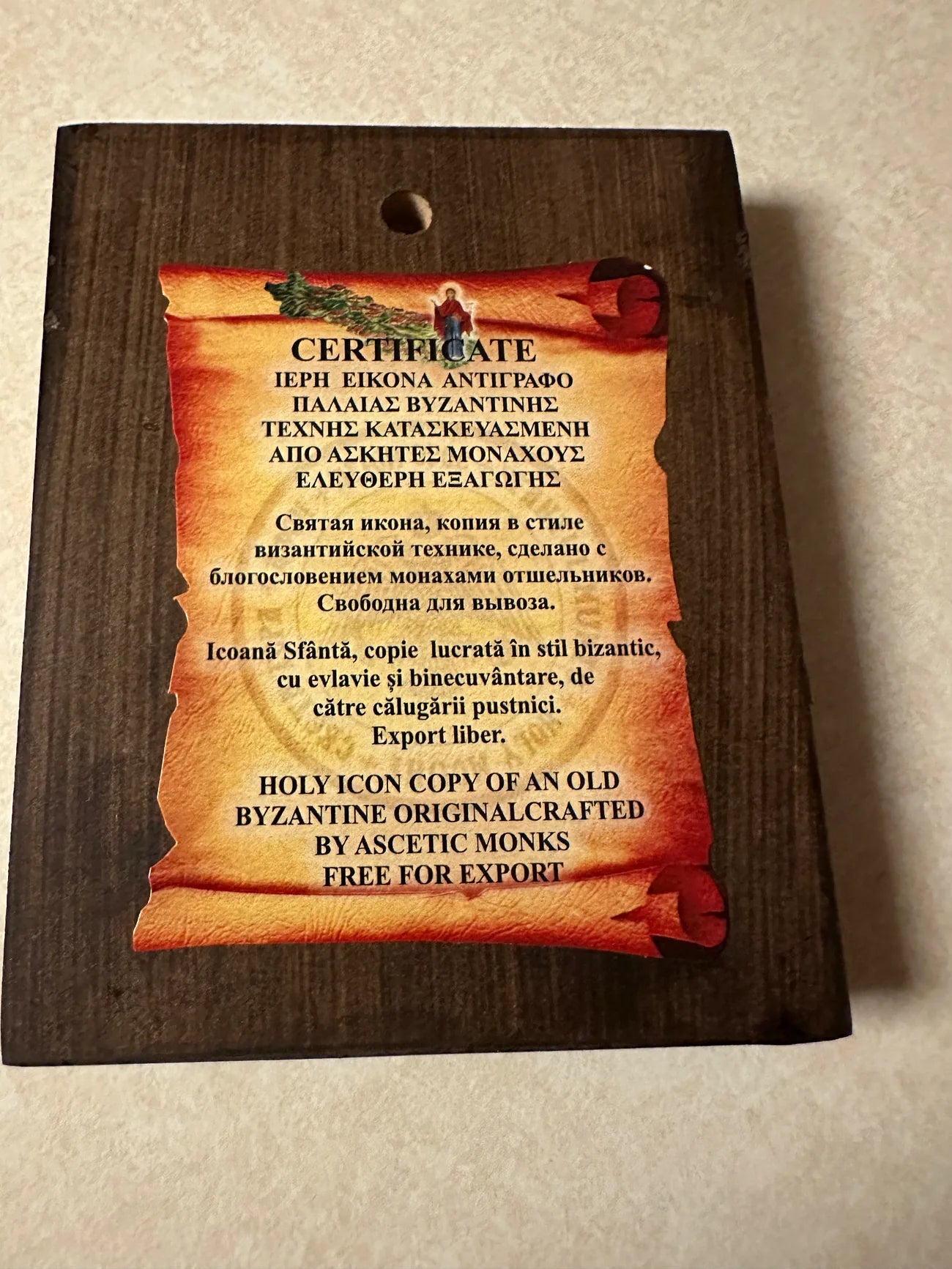 Certificate for a holy icon copy on a wooden plaque with text.