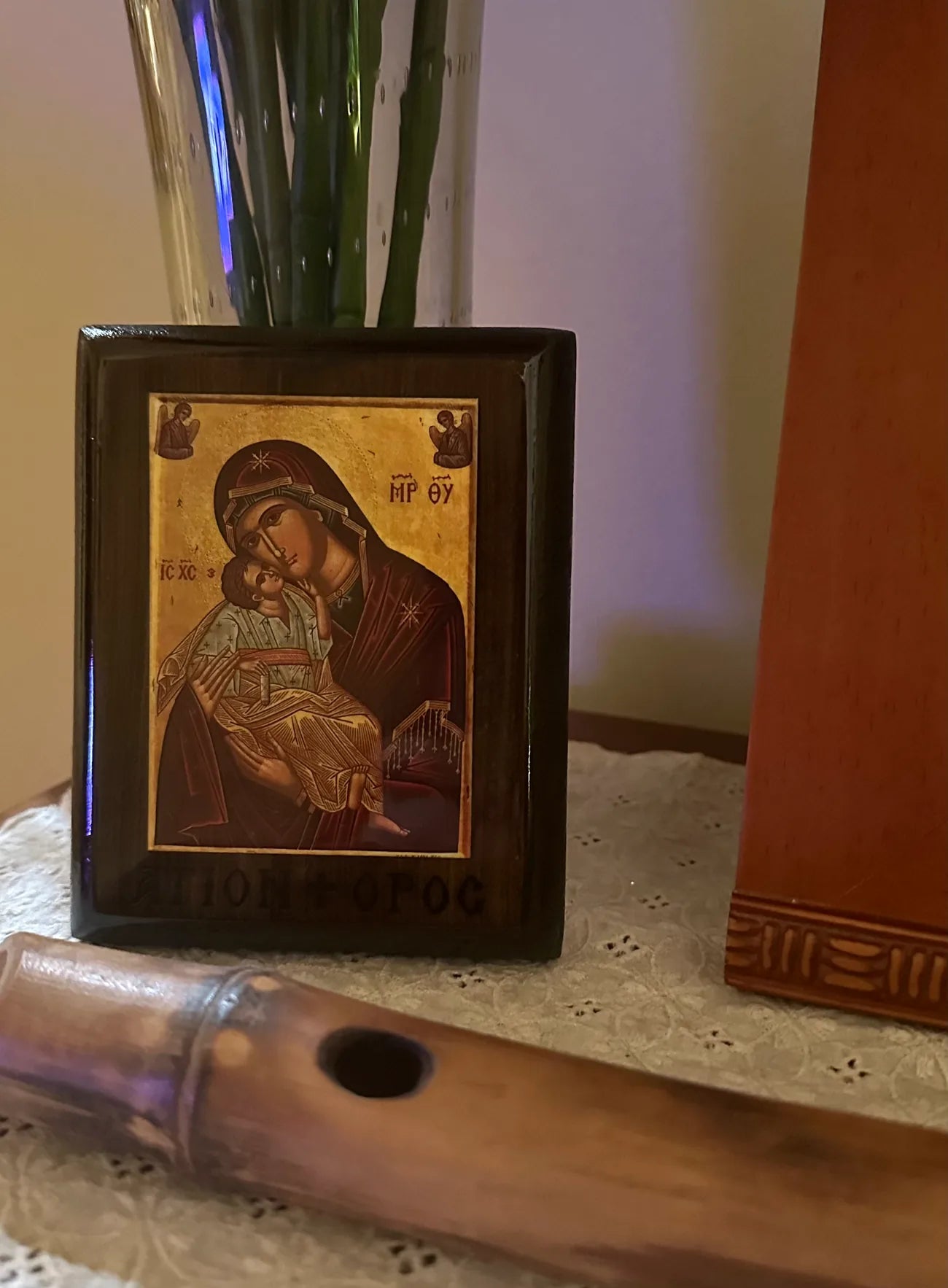 Small religious icon in a frame on a surface with a blurred background
