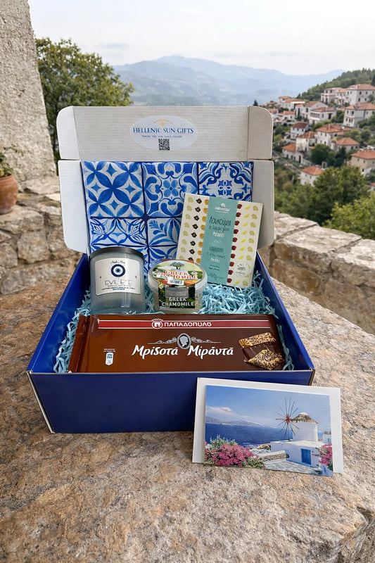 Gift box with products and a postcard on a stone surface with a scenic background