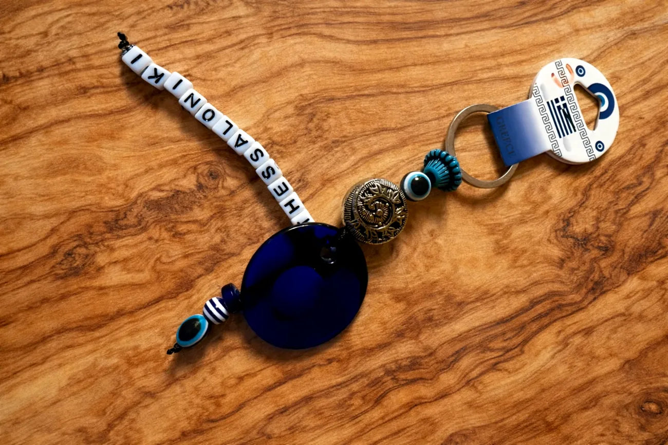 Keychain with beads and a blue pendant on a wooden surface