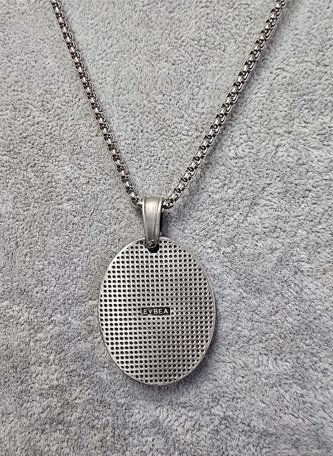 Titanium Warrior pendant—textured oval back with maker’s mark on stainless chain