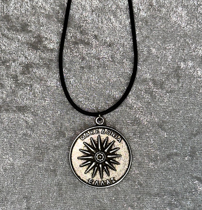 Necklace with a circular pendant featuring a star design on a textured gray background