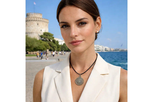 Woman wearing a necklace with a castle and sea in the background